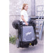 Worker carrying Johnny Vac Manual Floor Sweeper JV320 on road

