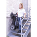 Worker carrying Johnny Vac Manual Floor Sweeper JV320 on stairs

