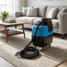 Mytee HP90 Stingray heated automotive detail extractor positioned in modern living room with soft lighting, emphasizing its compact design.