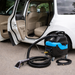 Car cleaning equipment on the ground next to an open car door.