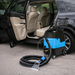 Car cleaning machine next to an open car door with a vehicle in the background
